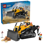 The LEGO® City Yellow Bulldozer by Legos - Toyhouse includes 682 pieces, a large yellow and black construction vehicle playset, two construction worker minifigures, and accessories. Box is visible in the background.