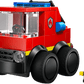 The Legos - Toyhouse LEGO® City Rides - Fire Truck is a red building kit with large black wheels, a blue siren, and a smiling yellow figure—perfect for kids who love creative play.