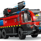 The Legos - Toyhouse LEGO® City Airport Fire Truck features six wheels, a red and black body with yellow safety stripes, and includes a firefighter minifigure in the cab.
