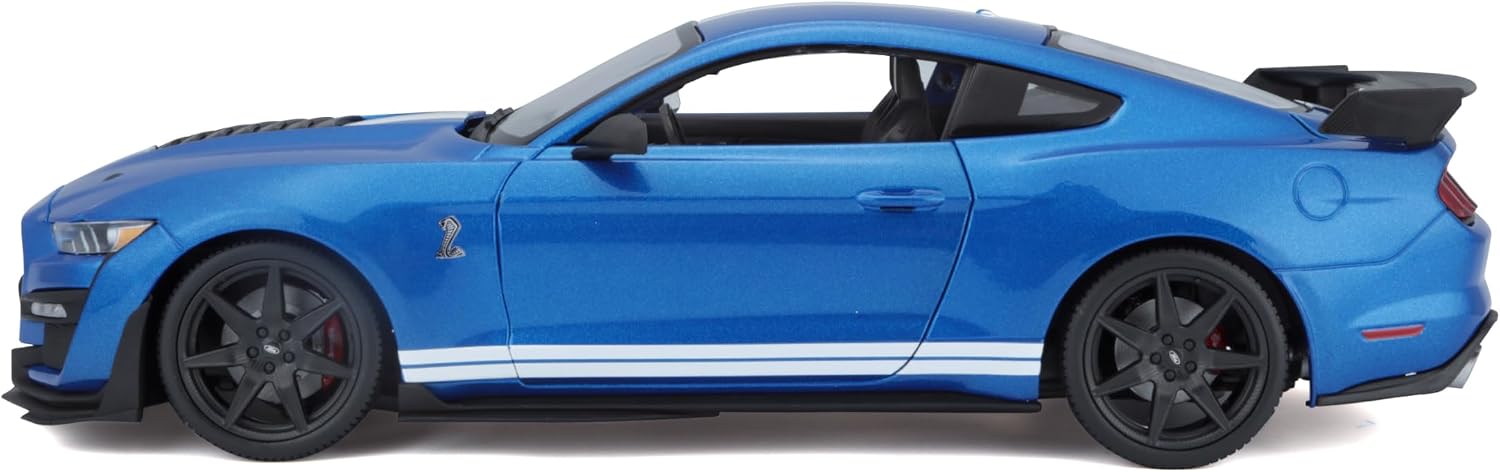 The Maisto 1:18 SE 2020 Mustang Shelby GT500 die-cast model features a striking blue finish with white racing stripes, black wheels, and a rear spoiler, showcased from the side against a white background—perfectly crafted for collectors and enthusiasts seeking authentic detail.