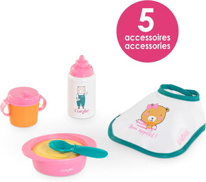The Corolle Mealtime Set - Pink includes a sippy cup, baby bottle, bowl with spoon, and bib—5 accessories for pretend feeding fun. Perfect for fans of Corolle baby dolls.
