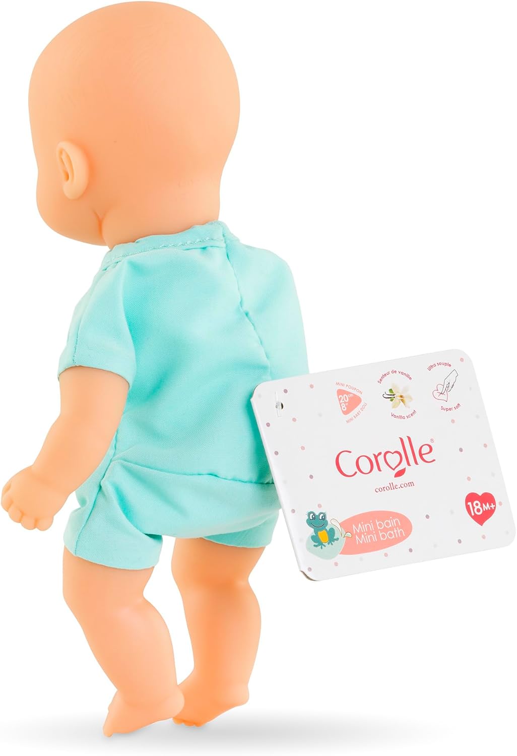 The Corolle Mini Bath Doll - Blue is a bald baby doll in a light blue outfit, shown from the back with a Corolle tag. Made of soft touch vinyl, it's perfect for playtime in or out of water.