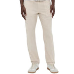 A person wearing the Faherty Dune Utility Pant, featuring garment-dyed stretch twill and an elastic waistband, paired with white sneakers and standing against a plain background.