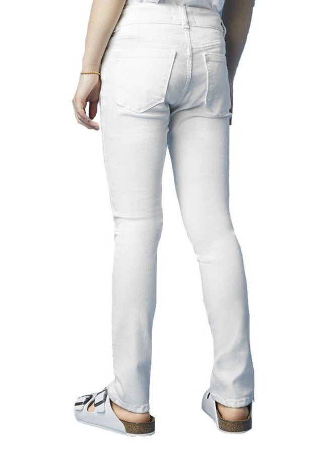 A person standing wearing DL1961 Chloe Skinny Jeans and white shoes with a cork sole.