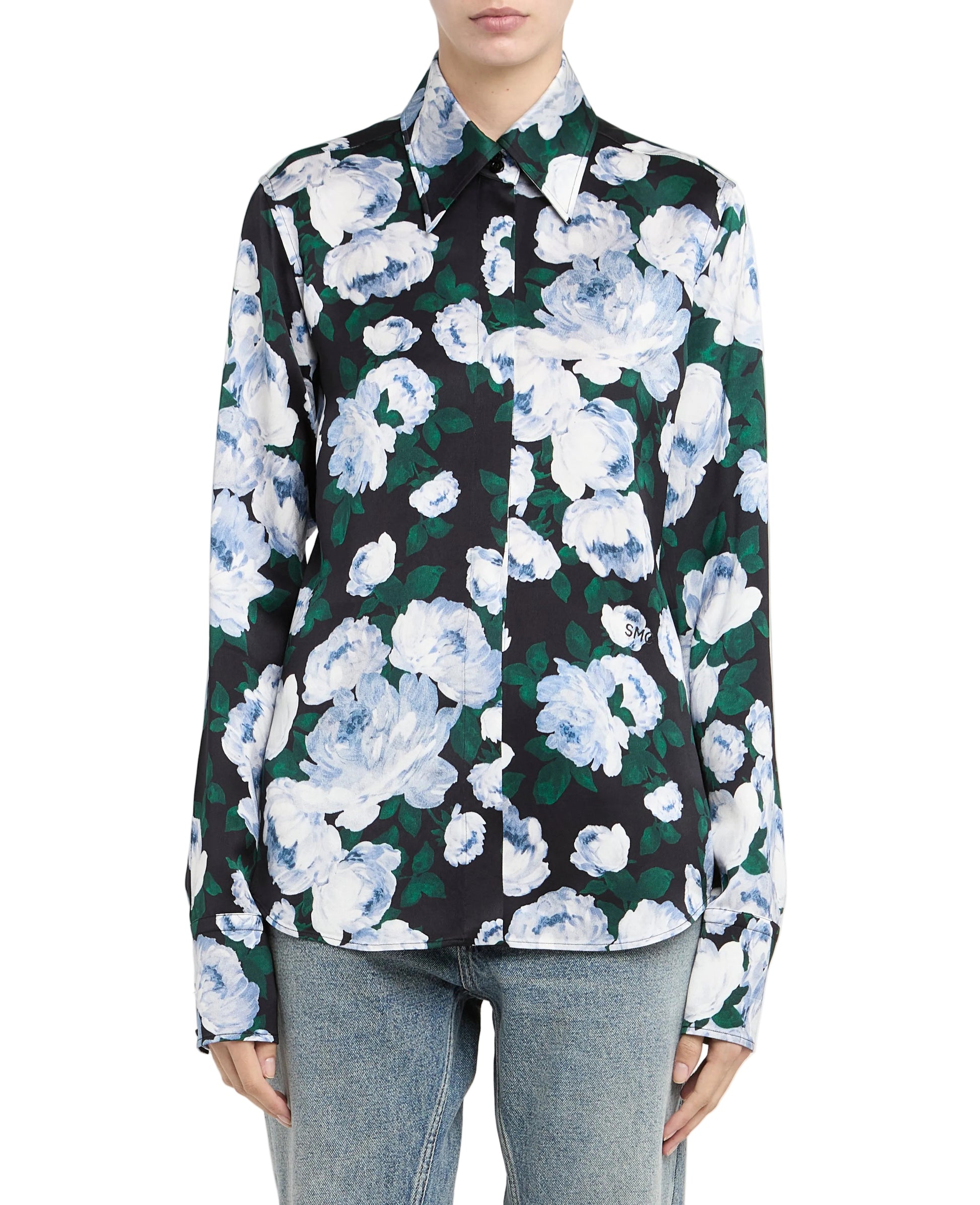 A person wearing the Stella McCartney Bunch of Roses Shirt, a black button-up with blue and white floral print, paired with light blue jeans, stands against a plain background.
