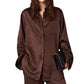 A long-sleeved brown Stella McCartney Star Silk Jacquard Shirt worn with matching trousers and a black chain-strap clutch.