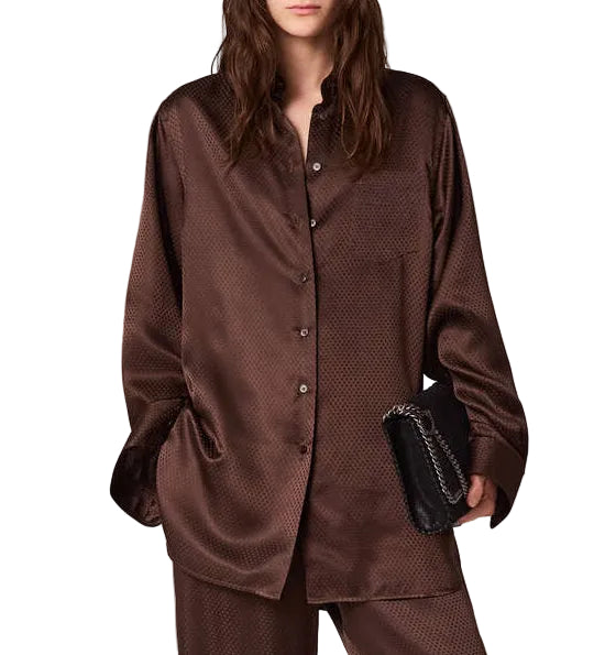 A long-sleeved brown Stella McCartney Star Silk Jacquard Shirt worn with matching trousers and a black chain-strap clutch.