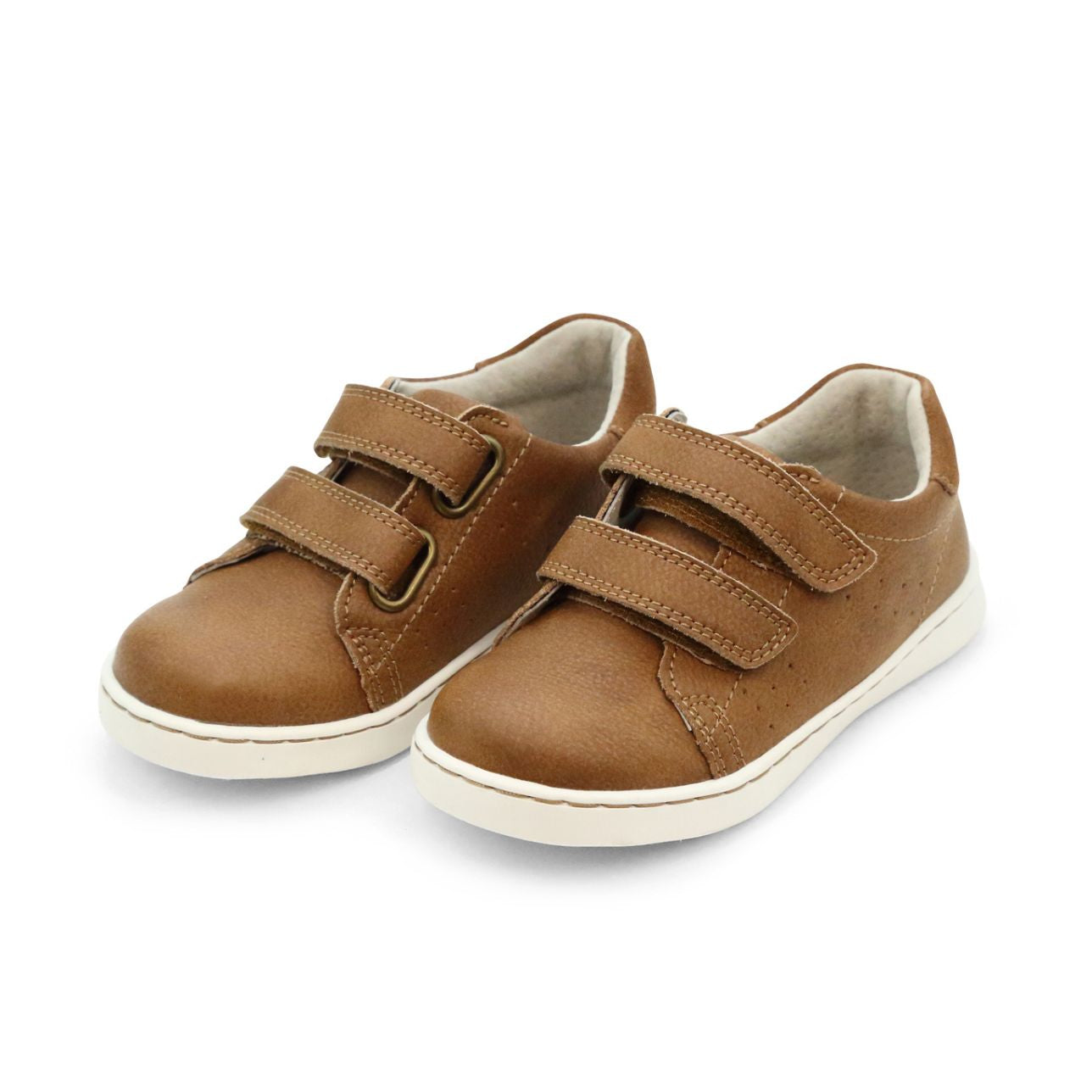 A pair of L'Amour Shoes Boys' Kyle Double Strap Sneakers with brown uppers, white soles, velcro straps, and a memory foam leather sockbed are shown side by side on a plain white background.
