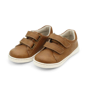 A pair of L'Amour Shoes Boys' Kyle Double Strap Sneakers with brown uppers, white soles, velcro straps, and a memory foam leather sockbed are shown side by side on a plain white background.