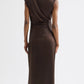 A person faces away, wearing TWP's On The Side Dress—a sleeveless, dark brown silk charmeuse dress with subtle draping and gathered detailing on one side.