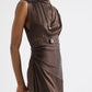 Model wears TWP's On The Side Dress, a brown sleeveless silk charmeuse style with side ruching, paired with two long necklaces, posed against a plain light background.