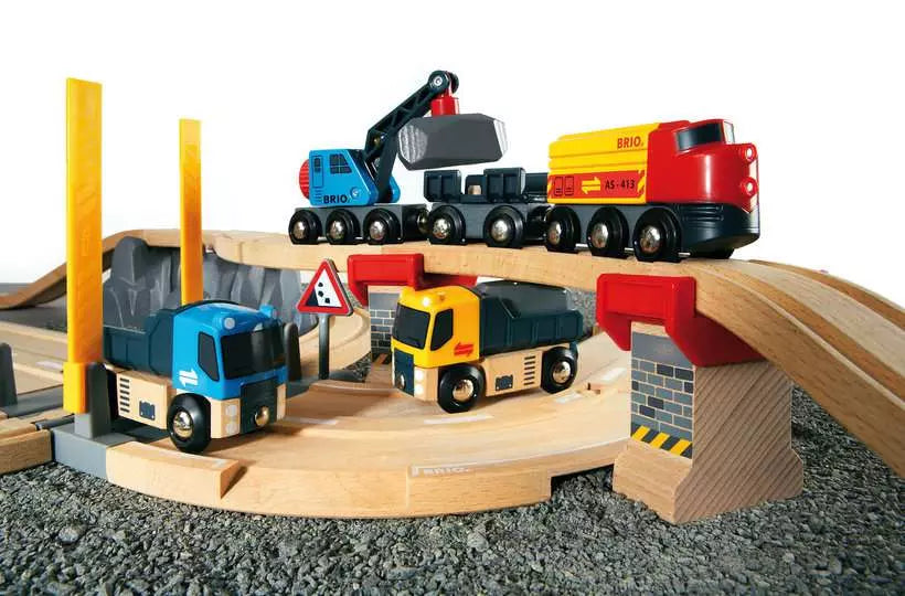 A wooden toy train set with construction vehicles and a railway bridge by Brio World. 