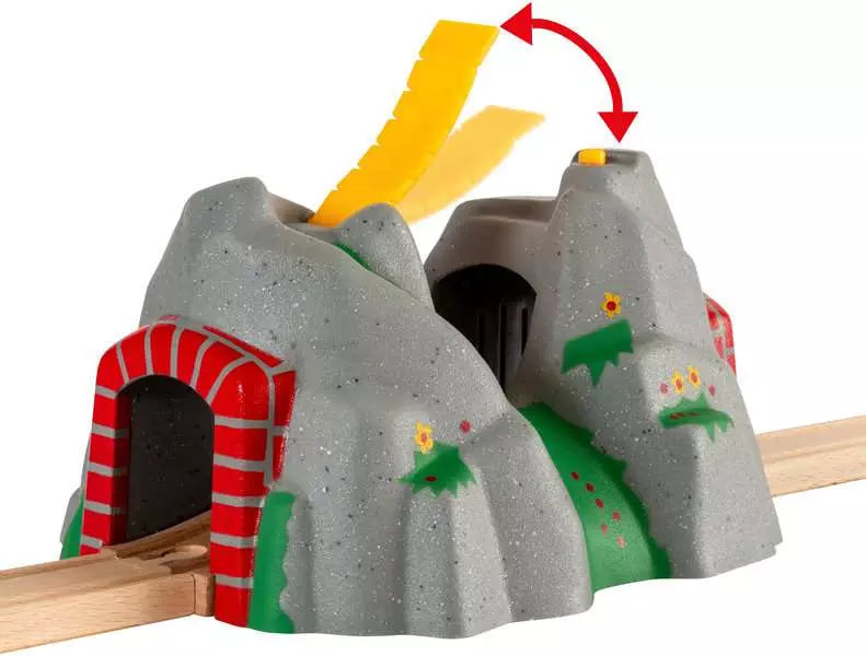 A toy train set featuring the BRIO World Adventure Tunnel with a yellow arrow pointing to a rock.