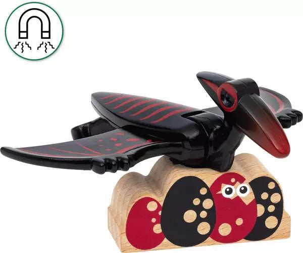 A magnet shaped like a black and red bird rests on a wooden block adorned with abstract designs, evoking the prehistoric themes of Brio's BRIO World Dinosaur Erupting Volcano.