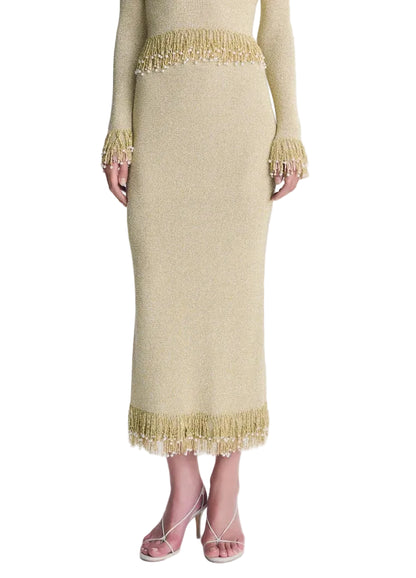 Simkhai Zeni Midi Skirt in gold metallic bouclé, featuring pearl-accented fringe trim at the waist and hem.