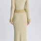 Back view of the Simkhai Tali Pearl Fringe Top in a gold metallic bouclé knit with pearl fringe detailing at the waist, cuffs, and hem.