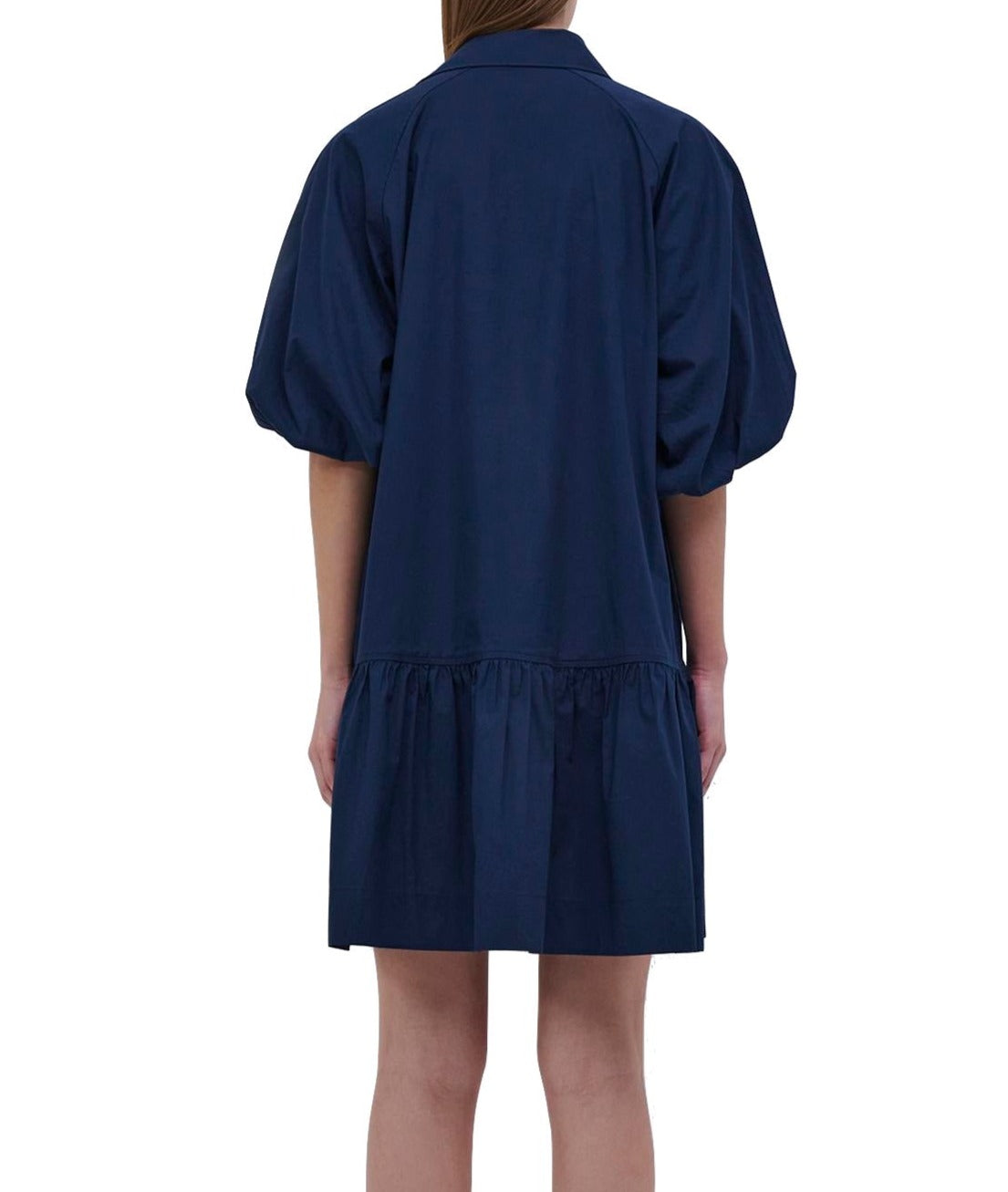 A woman wearing a White Simkhai Crissy Shirt Dress in a navy color.