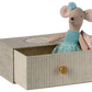 The Maileg Dance Mouse in Daybed, Little Sister, wears a blue dress and headband and sits in a patterned box with a gold knob, ready for her dance lesson.