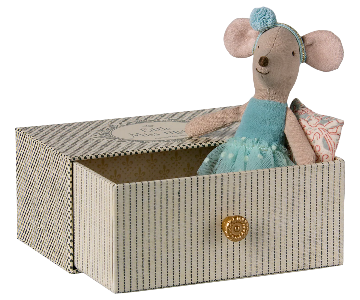 The Maileg Dance Mouse in Daybed, Little Sister, wears a blue dress and headband and sits in a patterned box with a gold knob, ready for her dance lesson.