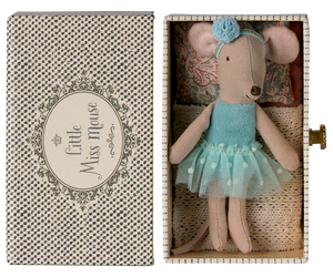 A small Maileg Dance Mouse in Daybed, Little Sister, wears a blue dress and headband and lies in a patterned box.