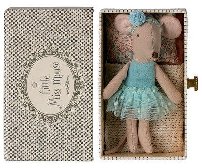 A small Maileg Dance Mouse in Daybed, Little Sister, wears a blue dress and headband and lies in a patterned box.