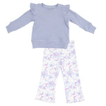 The Angel Dear Girls' Ruffle Shoulder Waffle Shirt in soft lavender pairs perfectly with matching ribbed flare pants, both featuring a charming pink and blue floral pattern.