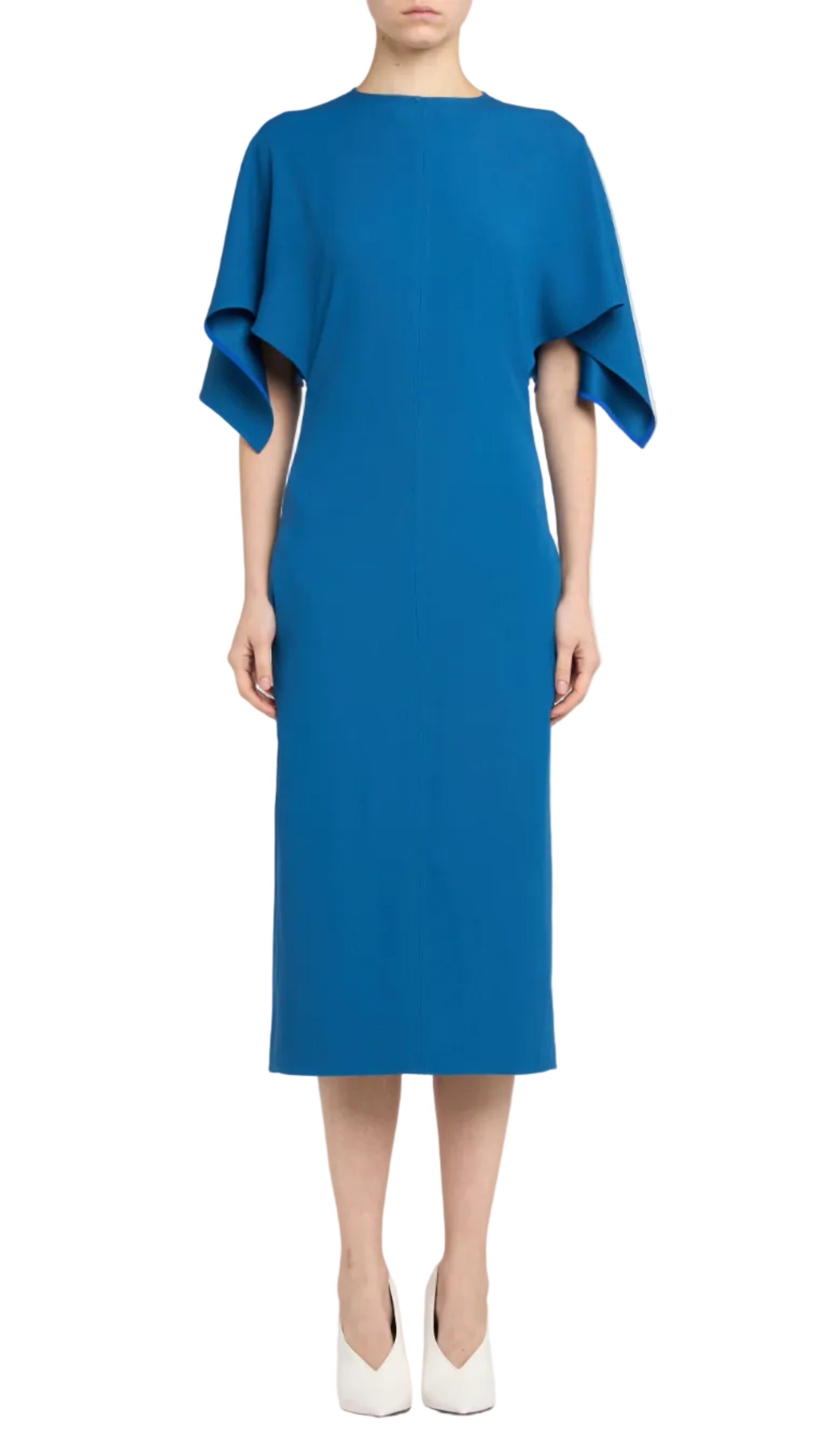 A woman models the Stella McCartney Royal Blue Midi Dress, featuring wide draped short sleeves, paired with white closed-toe heels against a white background.