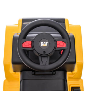 Close-up of the dashboard of the Freddo 6V CAT Dump Truck Ride-On, showcasing a black steering wheel with a CAT logo and red buttons. This toddler ride-on toy is designed to capture the authentic look and feel of real construction vehicles.