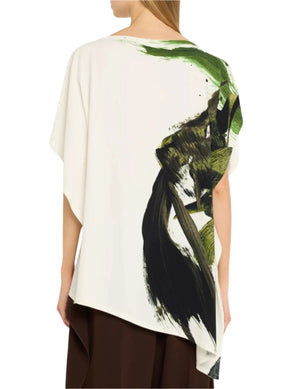 The woman wears a Jason Wu Collection Asymmetrical Printed Crepe Boatneck Top, featuring a white base with green and black brushstroke design, paired with a brown skirt.