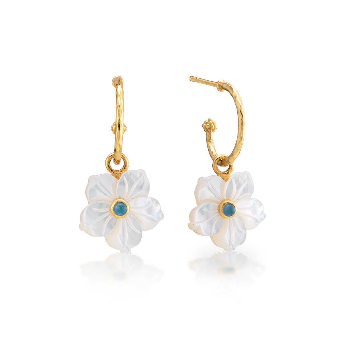 The Mermaid Garden Hoop Earrings with Flower Charm by Juliska Capucine De Wulf feature white carved petals and blue gemstone centers—a beautiful, modern take on mother of pearl earrings.