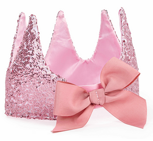 The Precious Pink Sequins Crown by Great Pretenders features four sparkling sequin points and a large pink fabric bow, perfect for princesses and creating sweet childhood memories.