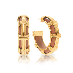 The Gaia Cage Hoop Earrings by Juliska Capucine De Wulf feature gold metal frames with brown inlays and elegant gold accents, shown upright and on their side against a white background.