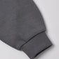 Close-up of a gray sweatshirt sleeve with ribbed cuff, displayed on a white background—a perfect complement to the Quincy Mae Baby Boys’ and Boys’ Sweatpant.