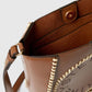 Close-up of the Stella McCartney Logo Raffia Trim Crossbody Bag, featuring brown vegan leather, cream stitching, gold magnetic snap closure, adjustable shoulder strap, and visible interior pockets.