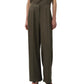 Wearing the Simkhai Kyra Wide Leg Pant in olive green with a tailored waistband and pleats, styled with a matching top and black open-toe heels for a polished yet relaxed look.