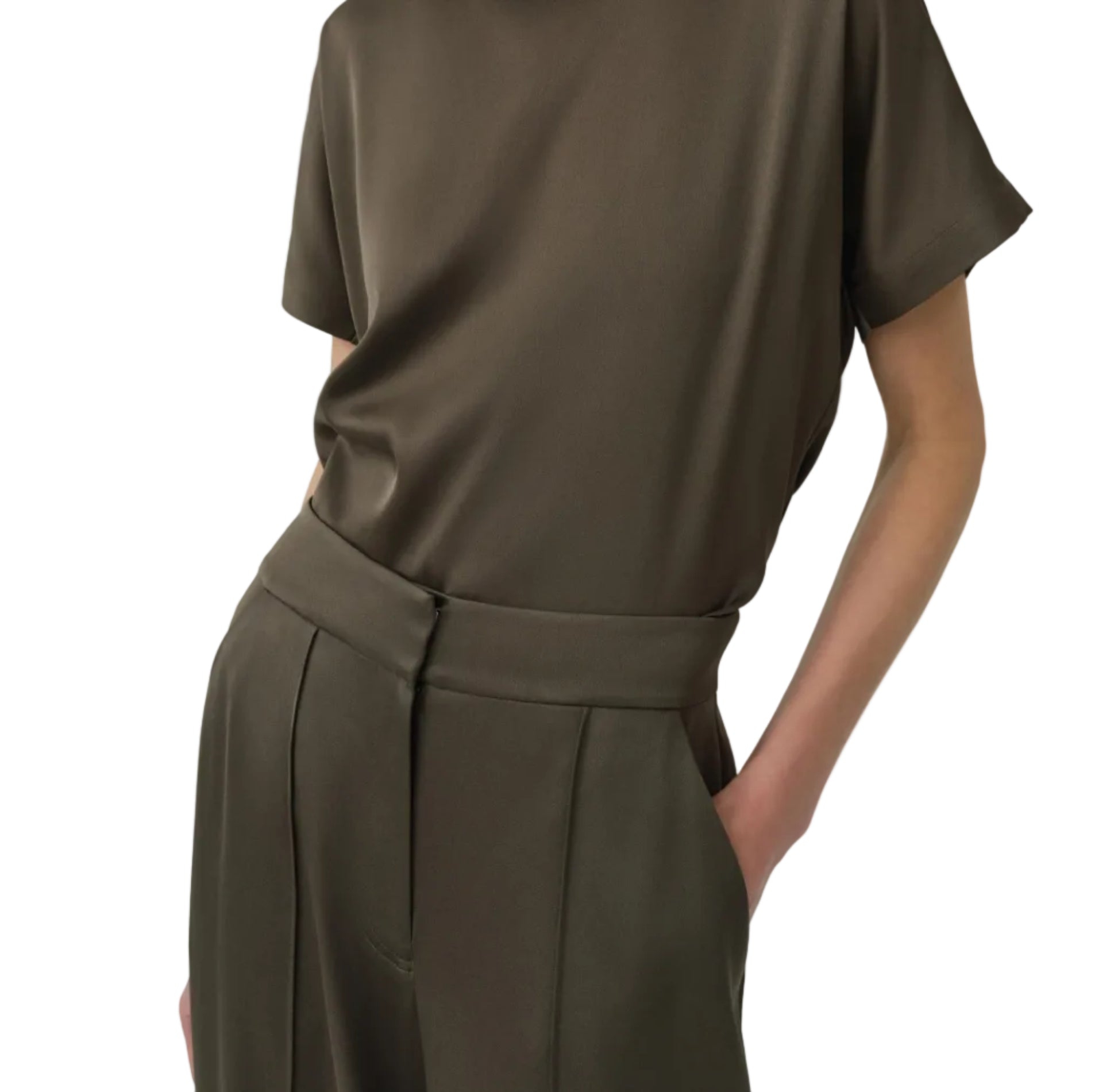 Wearing the Simkhai Kyra Wide Leg Pant with a tailored waistband, paired with an olive green short-sleeve top for a relaxed look—hands in pockets.