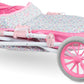 The Corolle Carriage - Bright Pink Floral is a folded baby doll stroller with a pink and white floral pattern, four wheels, and a curved, height-adjustable handlebar.