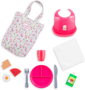 The Corolle Large Mealtime Set includes a floral tote, pink bib, divided plate, cup, napkin, knife, fork, play food items, and juice box—perfect accessories for My Big Doll Corolle and other large dolls.