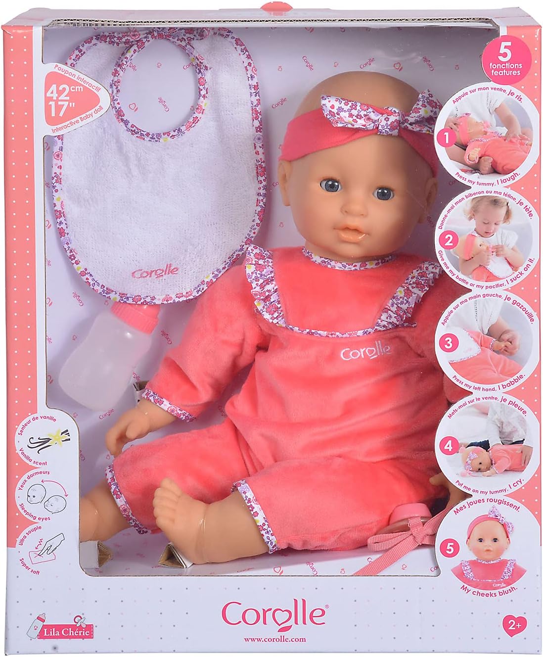 Corolle Lila Chérie 17" is a large baby doll for ages 2+, dressed in a pink floral outfit with headband, bib, and pacifier. Soft-touch vinyl doll comes in packaging that highlights its interactive features.