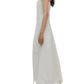 A woman in the Simkhai Ellery Bustier Midi Dress—sleeveless with a floral pattern and scalloped hem—pairs it with strappy sandals, standing in profile against a plain background.