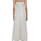 A woman, seen from the back, wears the Simkhai Ellery Bustier Midi Dress—a sleeveless white broderie anglaise dress with thin straps—paired with open-toe heels.