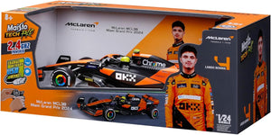 Box containing a 1:24 scale Maisto R/C McLaren MCL38—a thrilling radio control vehicle from Maisto—showcased in vibrant packaging featuring images of the actual car, driver Lando Norris, and highlights of the McLaren Team MCL38. Perfect for Formula Racing fans and collectors alike.