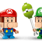 Two blocky toy figures—Baby Mario in red and Baby Luigi in green—hold pixelated hammers against a white background. These LEGO® Super Mario™ Mario Kart™ figures by Legos - Toyhouse are perfect collectibles for fans.