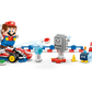 A hand places a LEGO® Mario™ figure into the LEGO® Super Mario™ Mario Kart™ – Interactive LEGO® Mario™ & Standard Kart by Legos - Toyhouse, surrounded by racing obstacles like a Thwomp, road signs, cones, and a finish line.
