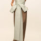 Bernadette Lina Dress: a strapless midi featuring a pale green bustier bodice with a large taffeta bow, a long mocha column skirt, and black patent leather pumps.