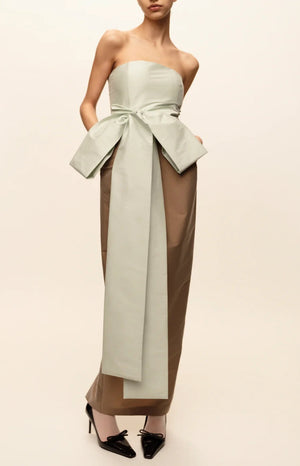 Bernadette Lina Dress: a strapless midi featuring a pale green bustier bodice with a large taffeta bow, a long mocha column skirt, and black patent leather pumps.