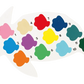 A white turtle-shaped palette from the Floss and Rock Paint By Numbers – Ocean kit includes 12 fish-shaped, numbered paint colors (1–12) in shades such as pink, red, blue, green, yellow, and orange.