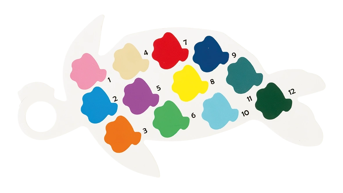 A white turtle-shaped palette from the Floss and Rock Paint By Numbers – Ocean kit includes 12 fish-shaped, numbered paint colors (1–12) in shades such as pink, red, blue, green, yellow, and orange.