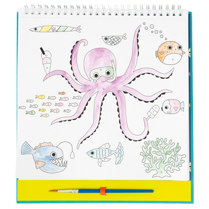 A drawing pad displays a vibrant underwater scene featuring a purple octopus with goggles, colorful fish, coral, and a paintbrush beneath the illustration—an ideal source of inspiration for the Floss and Rock Paint By Numbers - Ocean kit or any creative kids art project.