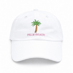 The Bits & Bows Palm Beach Hat is a girls’ white baseball cap featuring an embroidered green palm tree with “PALM BEACH” in pink lettering centered on the front—a fun and stylish accessory that adds a pop of color to any outfit.